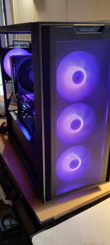 A black computer case with three glowing purple fans and visible internal components.