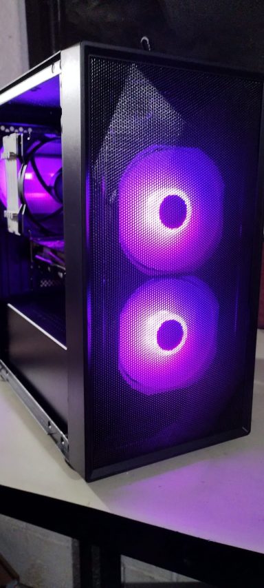 A desktop computer case with purple LED lighting and a transparent side panel.