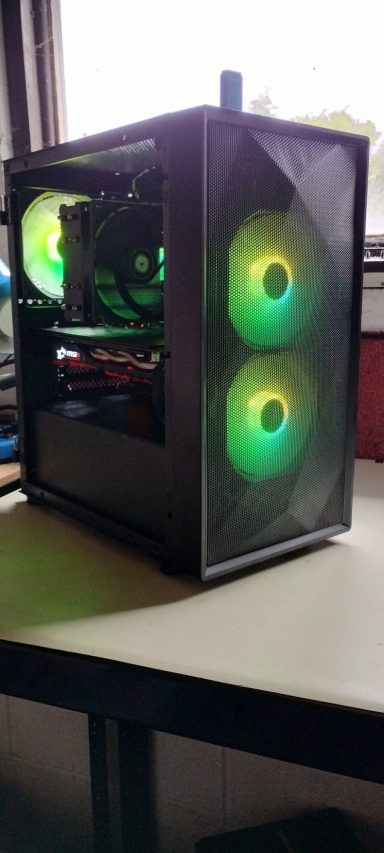 Black computer tower with green LED fans, displaying components through a transparent side panel.