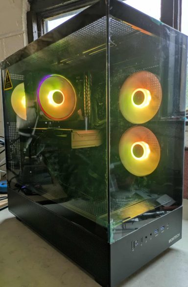 A sleek gaming PC case with RGB fans glowing in orange and green.