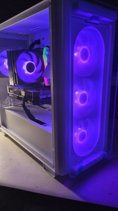A computer case with illuminated purple fans and internal components visible.