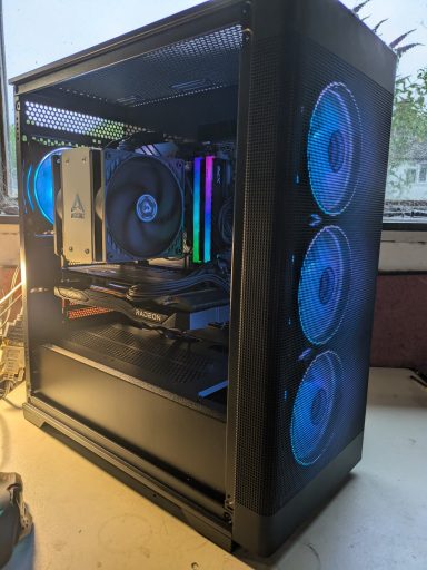 A gaming PC with transparent case, RGB fans, and glowing components inside.