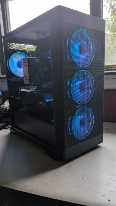 A black PC case with blue LED fans and a glass side panel.