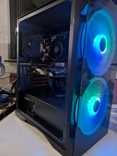 A black computer case with blue LED fans and a transparent side panel.