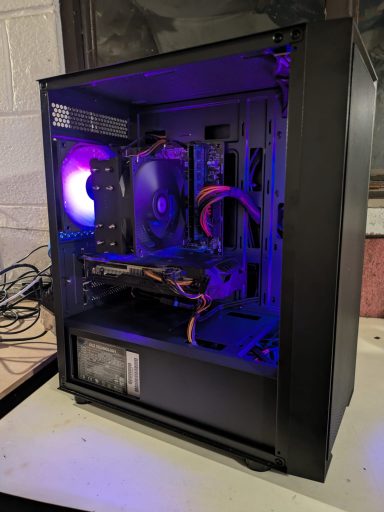 A computer case with internal components lit by purple LED lights.
