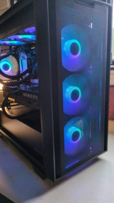A black computer case with three illuminated cooling fans.