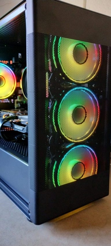 A gaming PC case with three colourful LED fans and a sleek design.