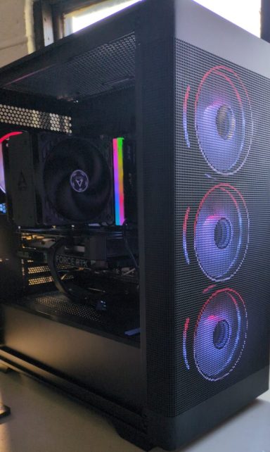 A sleek gaming PC with RGB fans and a transparent side panel.