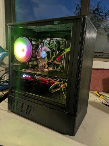 A black computer case with RGB lighting and visible components inside.