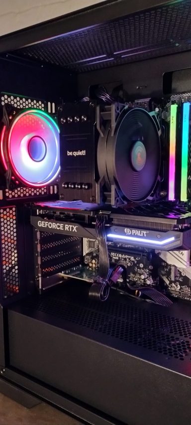 A desktop computer setup with RGB lighting and a sleek design.