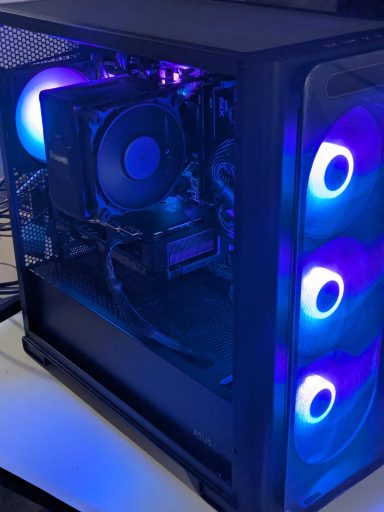 A modern PC case with blue LED lighting and visible internal components.